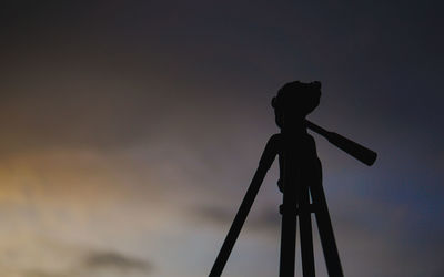 Silhouette of crane against sky during sunset