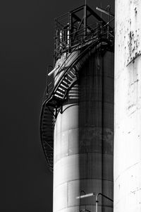 Low angle view of factory against sky at night