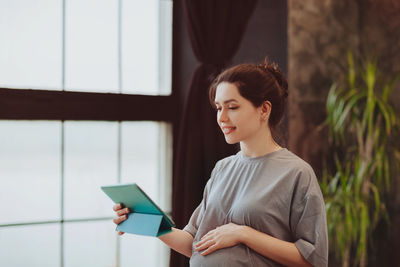 Young woman using digital tablet