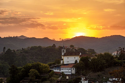 Old historic colonial church among the mountains of ouro preto city during sunset