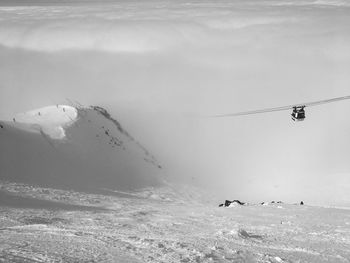 Overhead cable car over sea during winter