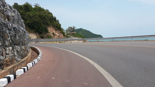 Road by mountain against clear sky