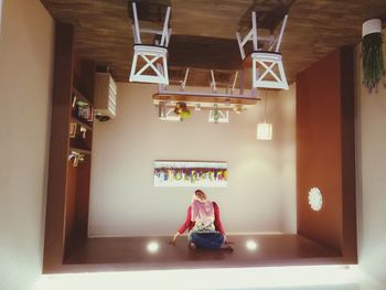 Man sitting in illuminated room