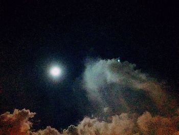 Low angle view of moon against sky at night