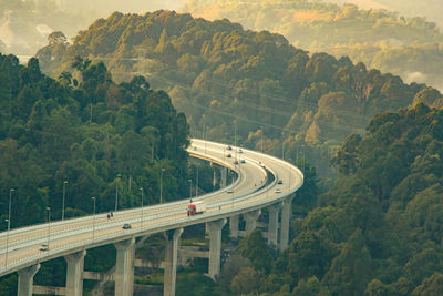 High angle view of bridge over highway against trees