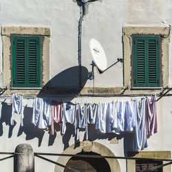 Low angle view of clothes hanging on wall against building