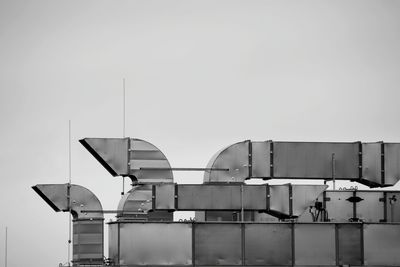 Low angle view of factory against clear sky