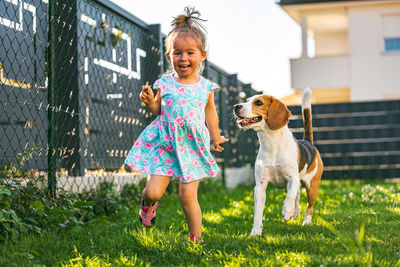 Full length of a girl with dog