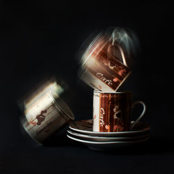 Close-up of coffee cup against black background