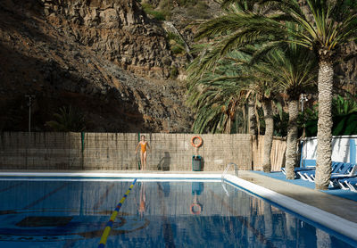 People walking by swimming pool