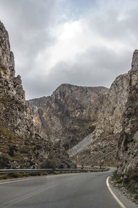 Road amidst mountains against sky