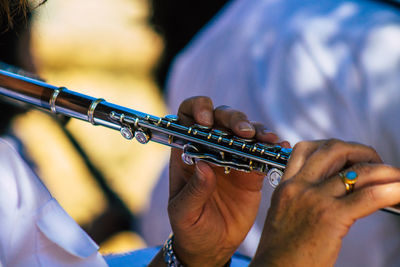 Midsection of man playing guitar