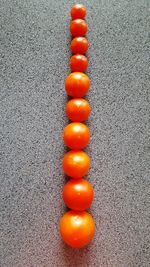 High angle view of orange eggs in row