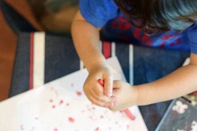 Directly above shot of boy coloring at home