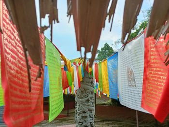 Multi colored buddhist flag hanging outside temple