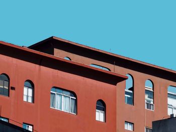 Low angle view of building against clear blue sky