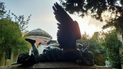 Statue against sky at sunset