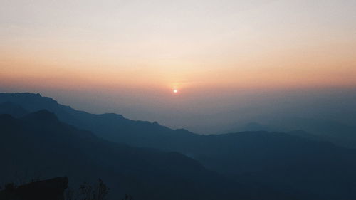 Scenic view of silhouette mountains against sky during sunset