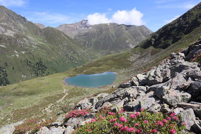 Scenic view of lake by mountains against sky