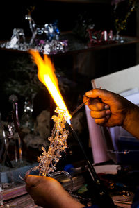 Cropped artist making glass product in workshop