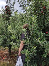 Man standing by plants