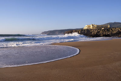 Scenic view of sea against clear blue sky