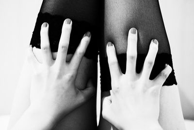 Close-up of hands over white background