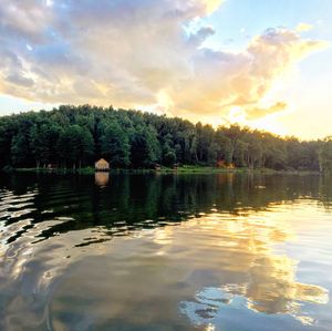 Scenic view of lake against sky at sunset