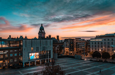 Buildings in city at sunset