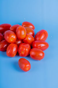 Close-up of cherries on table against blue background