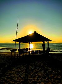 Scenic view of beach against sky during sunset