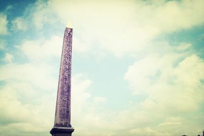 Low angle view of tower against cloudy sky