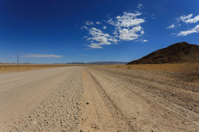 Scenic view of landscape against blue sky