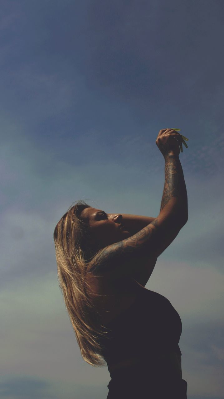 one person, sky, adult, nature, women, young adult, blue, cloud, arm, animal, animal themes, side view, arms raised, waist up, outdoors, hairstyle, bird, long hair, lifestyles, standing, one animal, portrait, day, leisure activity, limb