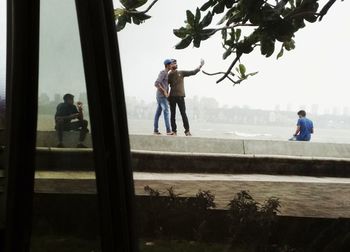 Men in park against sky