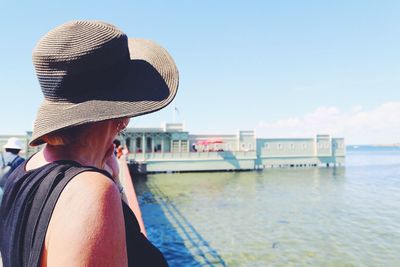 Woman with hat looking at the view in vacations