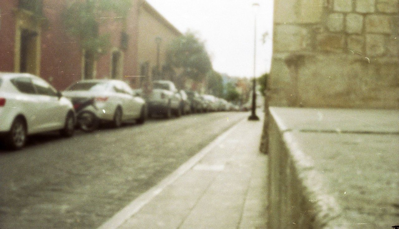 transportation, street, mode of transport, bicycle, land vehicle, selective focus, focus on foreground, road, built structure, architecture, men, the way forward, day, building exterior, metal, car, walking, outdoors, incidental people