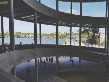 Reflection of people on bridge against sky