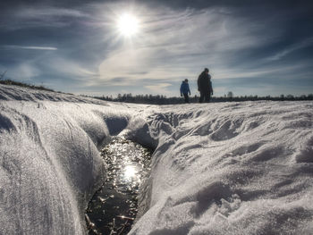 Unrecognizable people walking through snow mountain. snowy park, winter walk. selective focus