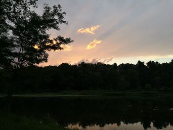 Scenic view of lake against sky at sunset
