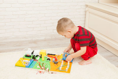 High angle view of boy playing with toy