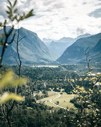 Scenic view of field and mountains against sky