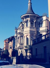 Buildings against clear blue sky