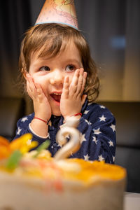 Close-up of cute birthday girl looking away