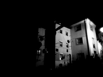 Low angle view of illuminated buildings against sky at night