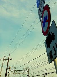 Low angle view of road sign against sky