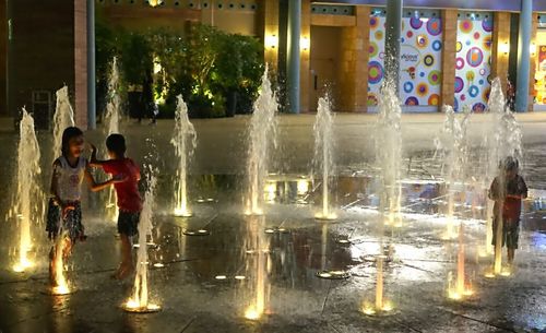 People in illuminated city at night