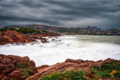 Scenic view of sea against storm clouds