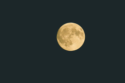 Low angle view of moon against clear sky at night