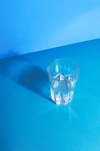 Close-up of glass against blue background